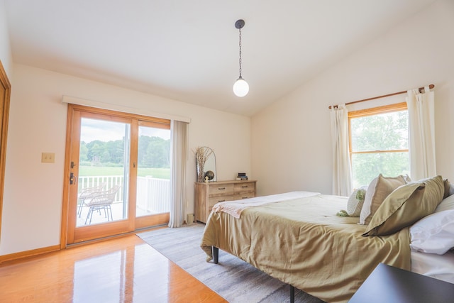 1684 W W County Line Rd, Sand Lake, MI 49343 - bedroom featuring vaulted ceiling, access to exterior, light wood-type flooring, and multiple windows