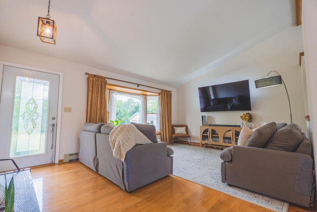 1684 W W County Line Rd, Sand Lake, MI 49343 - living room with lofted ceiling, a baseboard heating unit, and light wood-type flooring