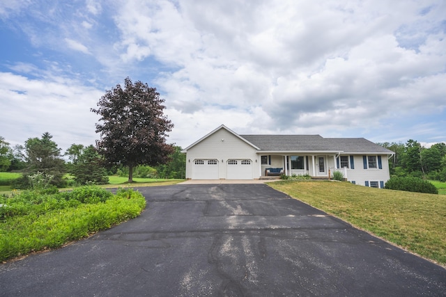 1684 W W County Line Rd, Sand Lake, MI 49343 - ranch-style house featuring an attached garage, asphalt driveway, and a front yard