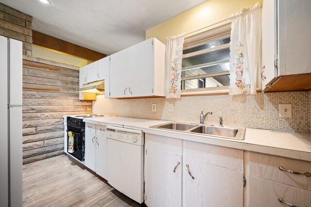 275 Benjamin St, Benton Harbor, MI 49022 - kitchen featuring white appliances, light countertops, backsplash, light wood-style floors, and under cabinet range hood