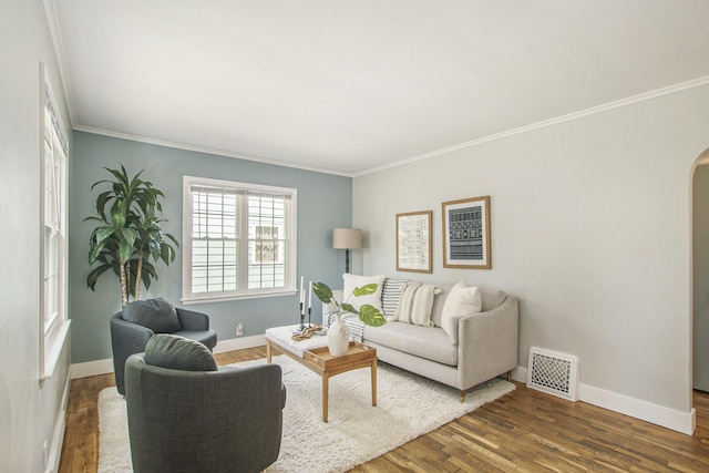 185 W 21st St, Holland, MI 49423 - living area with dark wood finished floors, crown molding, and arched walkways