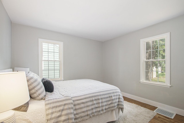 185 W 21st St, Holland, MI 49423 - bedroom with multiple windows and wood finished floors