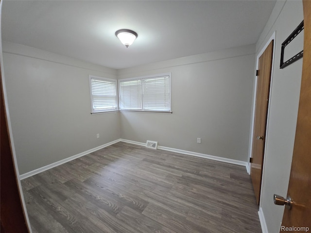 22024 Lester St, Clinton Township, MI 48035 - unfurnished bedroom featuring dark wood finished floors and baseboards