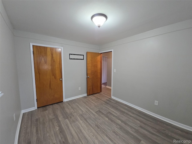 22024 Lester St, Clinton Township, MI 48035 - unfurnished bedroom with wood finished floors and baseboards