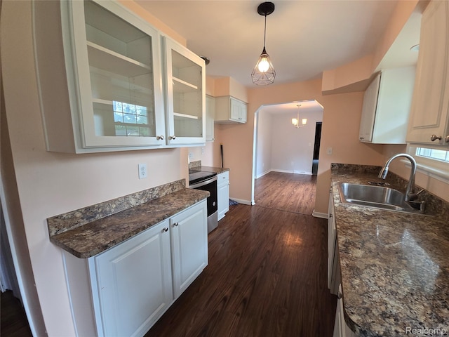 22024 Lester St, Clinton Township, MI 48035 - kitchen with stainless steel electric range, glass insert cabinets, dark wood-type flooring, arched walkways, and white cabinetry