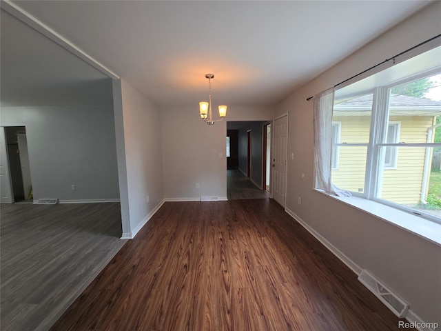 22024 Lester St, Clinton Township, MI 48035 - empty room with a chandelier and dark wood-style floors