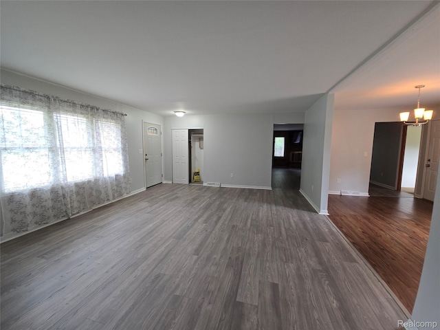 22024 Lester St, Clinton Township, MI 48035 - unfurnished living room featuring a chandelier and dark wood-style flooring