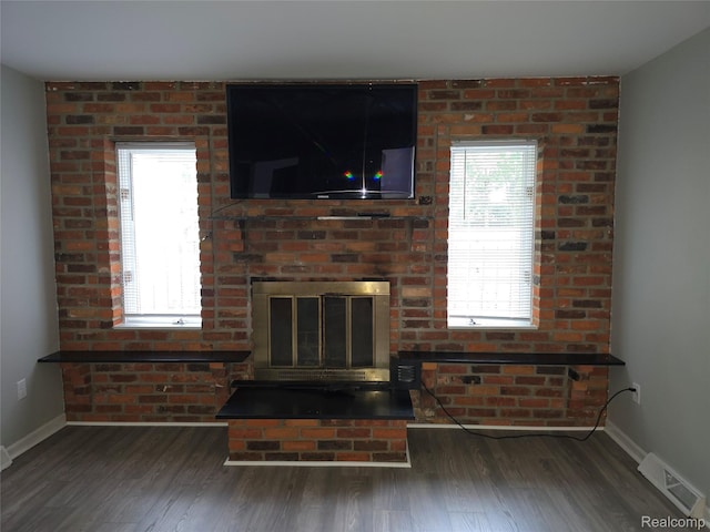 22024 Lester St, Clinton Township, MI 48035 - unfurnished living room with wood finished floors and a brick fireplace