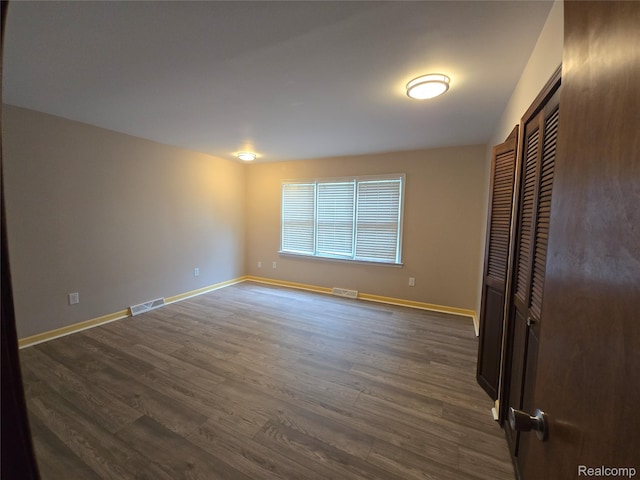 22024 Lester St, Clinton Township, MI 48035 - unfurnished bedroom with dark wood finished floors and a closet