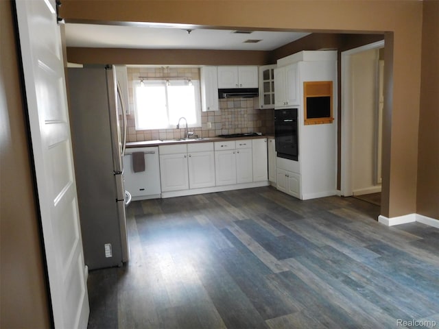 3351 Grant Rd, Rochester Hills, MI 48309 - kitchen with freestanding refrigerator, black oven, under cabinet range hood, decorative backsplash, and cooktop