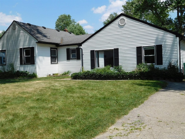 3351 Grant Rd, Rochester Hills, MI 48309 - view of front facade with a front lawn, a shingled roof, and a chimney