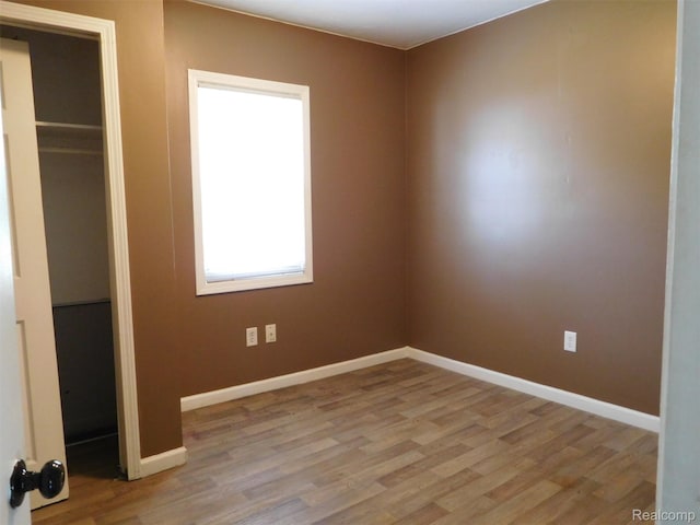 3351 Grant Rd, Rochester Hills, MI 48309 - unfurnished bedroom with light wood finished floors and a closet