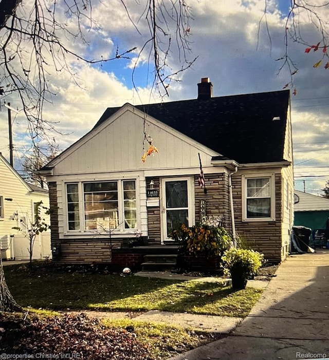 14633 College Ave, Dearborn, MI 48101 - bungalow with a chimney, stone siding, and a shingled roof