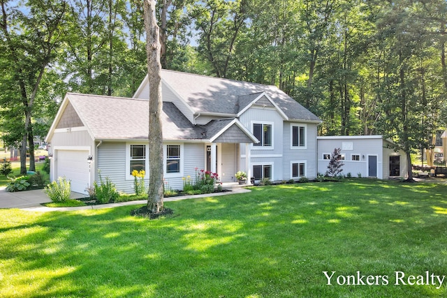 4005 Bullseye Ln, Dorr, MI 49323 - tri-level home with roof with shingles, a garage, a front lawn, and concrete driveway