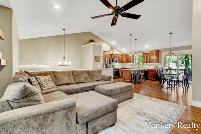 4005 Bullseye Ln, Dorr, MI 49323 - living area featuring a chandelier, lofted ceiling, ceiling fan, recessed lighting, and light wood finished floors