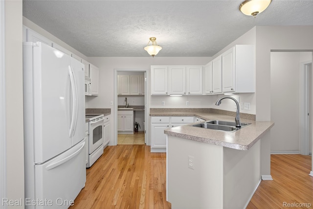 480 Hosta, Howell, MI 48843 - kitchen featuring white appliances, a peninsula, light wood-type flooring, white cabinetry, and a textured ceiling