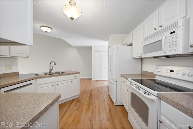 480 Hosta, Howell, MI 48843 - kitchen featuring white appliances, white cabinets, a textured ceiling, light wood-type flooring, and a peninsula