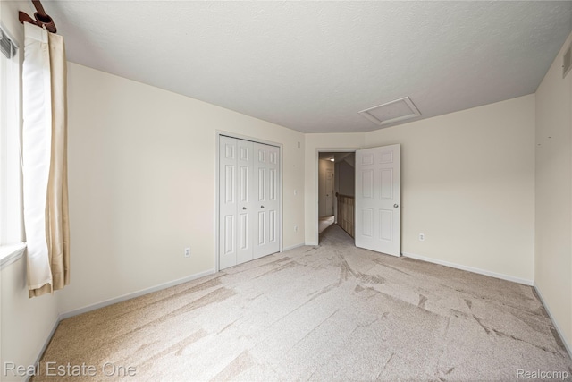480 Hosta, Howell, MI 48843 - unfurnished bedroom featuring carpet, attic access, and a closet