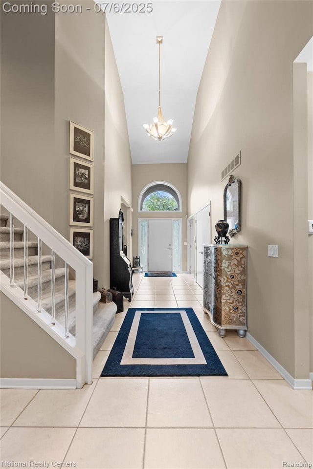 7319 Autumn Hill Dr, West Bloomfield, MI 48323 - tiled foyer entrance featuring high vaulted ceiling, stairs, and a chandelier