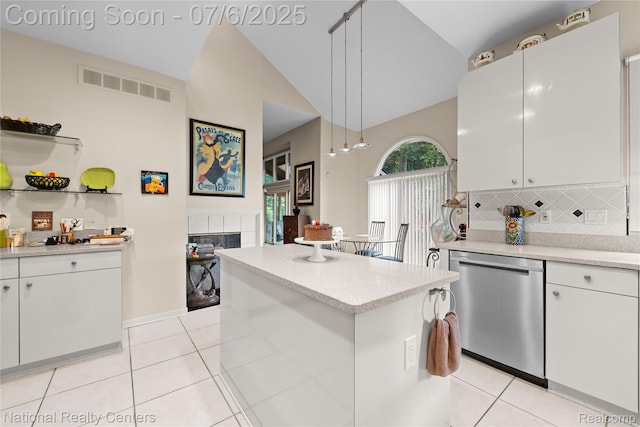 7319 Autumn Hill Dr, West Bloomfield, MI 48323 - kitchen featuring dishwasher, a tile fireplace, lofted ceiling, light tile patterned floors, and tasteful backsplash
