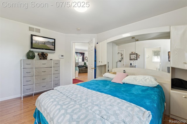 2187 Anoka St, Flint, MI 48532 - bedroom featuring wood finished floors and baseboards