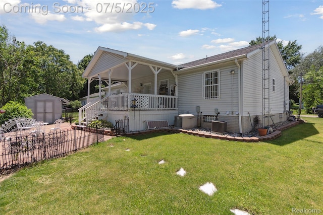 2187 Anoka St, Flint, MI 48532 - rear view of house featuring a storage unit, a lawn, covered porch, and stairs