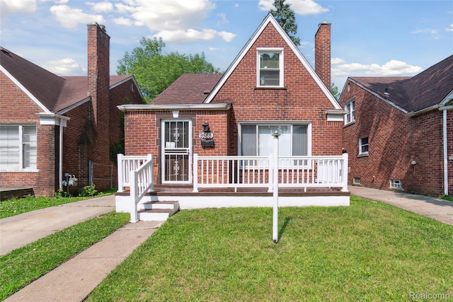 9585 Asbury Park, Detroit, MI 48227 - tudor-style house with a front yard, brick siding, a chimney, and a porch