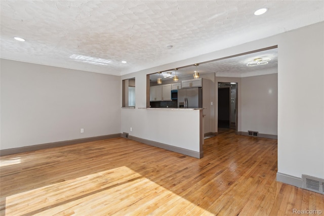 9585 Asbury Park, Detroit, MI 48227 - unfurnished living room with light wood finished floors and recessed lighting