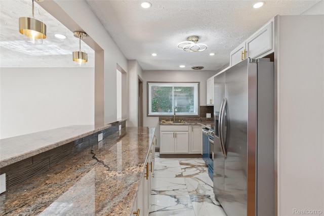 9585 Asbury Park, Detroit, MI 48227 - kitchen featuring stainless steel appliances, light marble finish flooring, light stone countertops, recessed lighting, and white cabinets