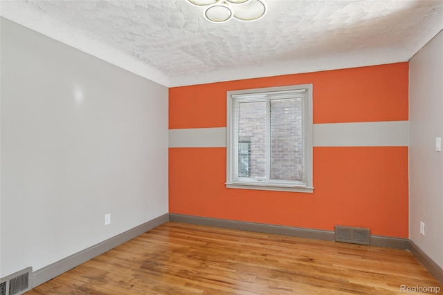 9585 Asbury Park, Detroit, MI 48227 - spare room featuring a textured ceiling and wood finished floors