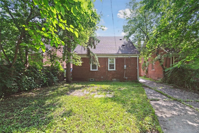 9585 Asbury Park, Detroit, MI 48227 - back of house featuring brick siding, crawl space, a lawn, and roof with shingles