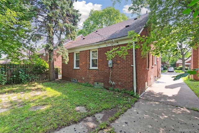 9585 Asbury Park, Detroit, MI 48227 - view of side of home featuring brick siding, a shingled roof, and concrete driveway