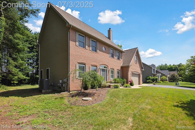 7155 Campbell Mills Ct, Brighton, MI 48116 - view of front of property with a garage, a chimney, a front yard, concrete driveway, and brick siding
