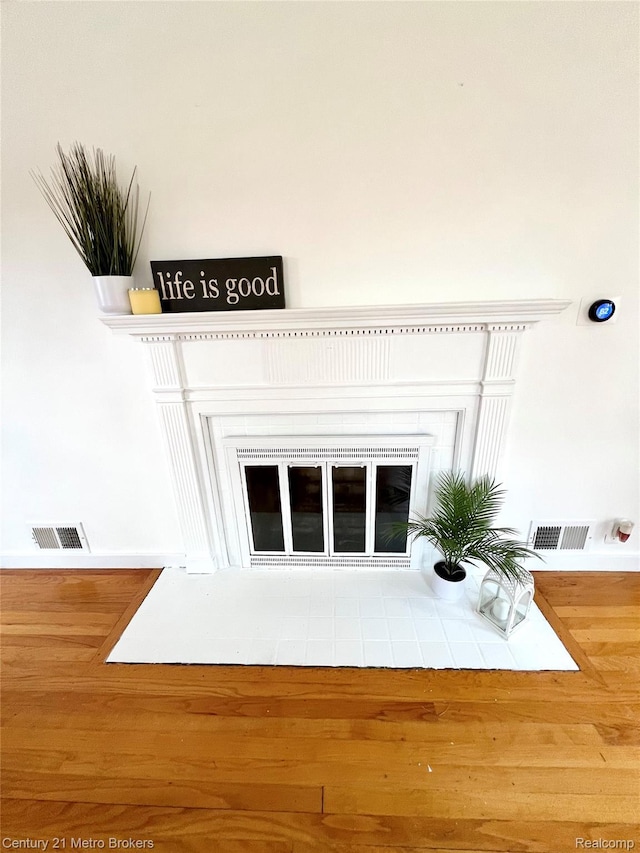 2122 Pierce St, Flint, MI 48503 - detailed view of a fireplace with flush hearth and wood finished floors