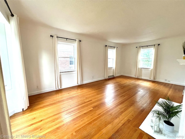 2122 Pierce St, Flint, MI 48503 - empty room featuring light wood finished floors and a textured ceiling