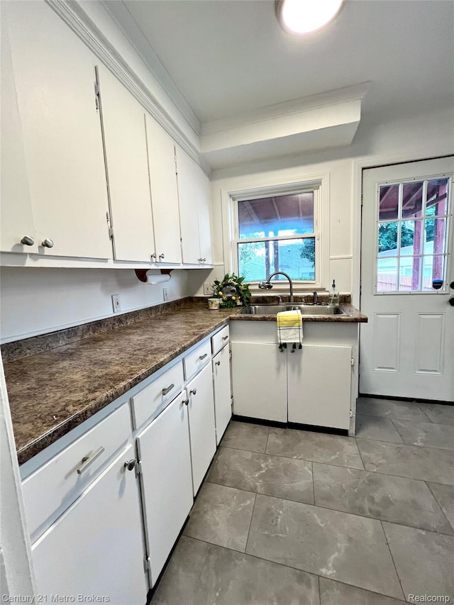 2122 Pierce St, Flint, MI 48503 - kitchen featuring healthy amount of natural light, white cabinetry, and light tile patterned floors