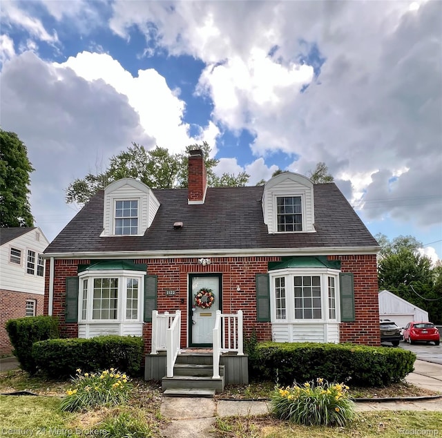 2122 Pierce St, Flint, MI 48503 - cape cod house with brick siding and a chimney