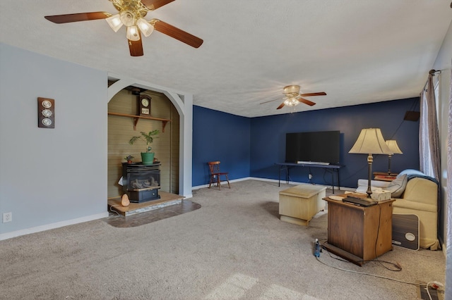 70661 Dennis Dr, Niles, MI 49120 - living room featuring a ceiling fan, a wood stove, and carpet floors