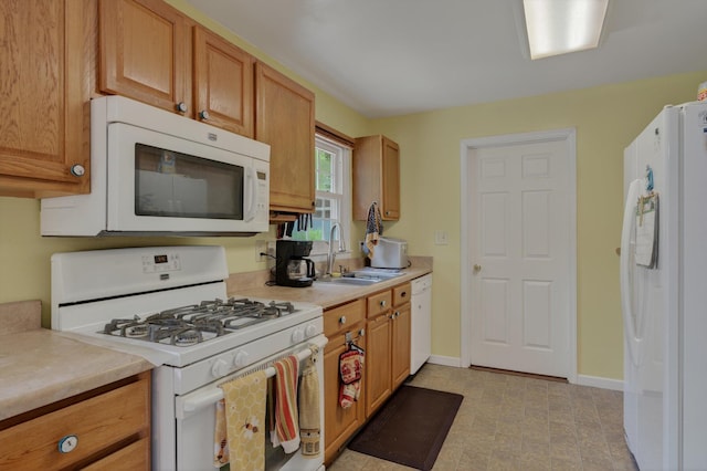 70661 Dennis Dr, Niles, MI 49120 - kitchen featuring white appliances, light countertops, light floors, and brown cabinetry