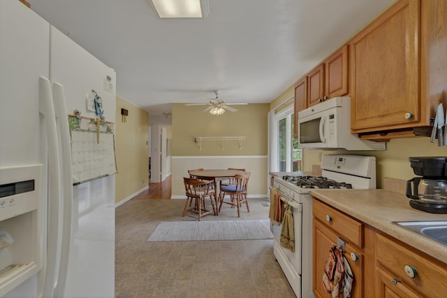 70661 Dennis Dr, Niles, MI 49120 - kitchen featuring white appliances, light countertops, ceiling fan, and brown cabinets