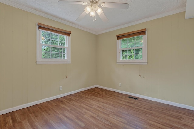 70661 Dennis Dr, Niles, MI 49120 - spare room featuring healthy amount of natural light, wood finished floors, a textured ceiling, a ceiling fan, and crown molding