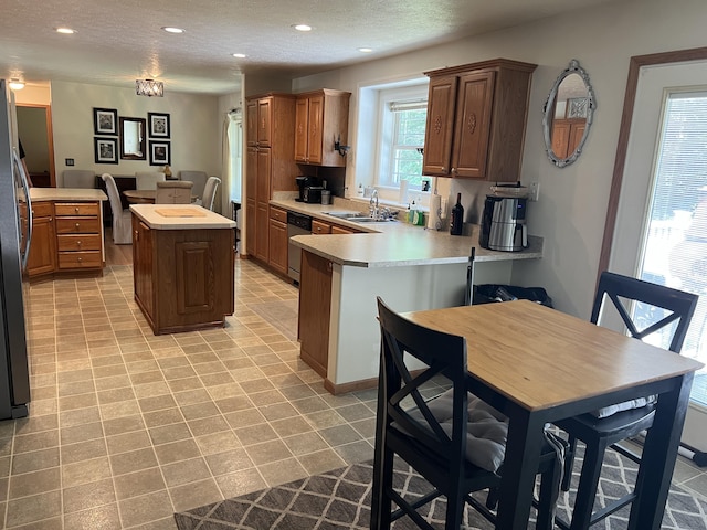 260 Treml, Michigan, MI 49411 - kitchen with a peninsula, a center island, light countertops, recessed lighting, and a textured ceiling