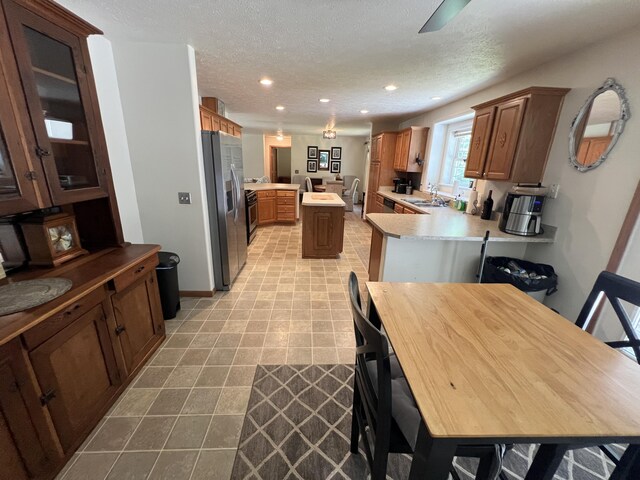260 Treml, Michigan, MI 49411 - kitchen featuring stainless steel fridge, a peninsula, recessed lighting, light countertops, and a textured ceiling