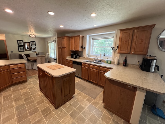 260 Treml, Michigan, MI 49411 - kitchen featuring stainless steel dishwasher, a peninsula, plenty of natural light, light countertops, and a textured ceiling