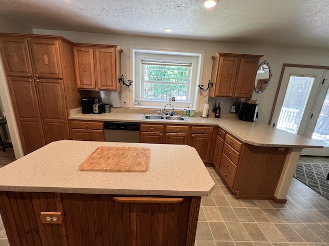 260 Treml, Michigan, MI 49411 - kitchen with dishwasher, a peninsula, a textured ceiling, light countertops, and a center island