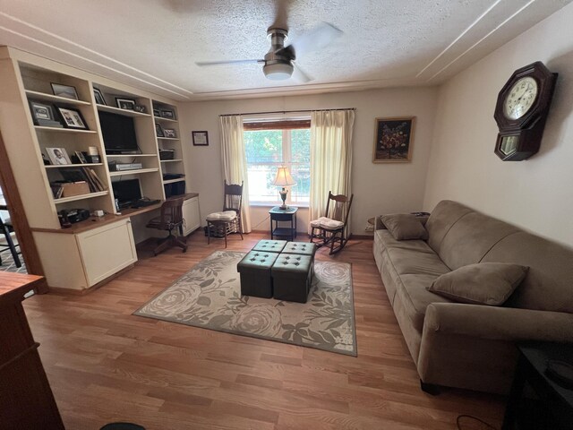 260 Treml, Michigan, MI 49411 - living room featuring ceiling fan, light wood-style floors, a textured ceiling, and built in study area