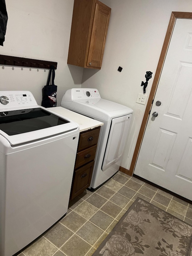 260 Treml, Michigan, MI 49411 - laundry room featuring cabinet space, washer and clothes dryer, and dark tile patterned floors