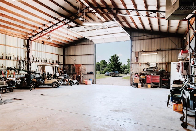 2098 Fisher Ct, Howell, MI 48855 - garage featuring a workshop area and metal wall