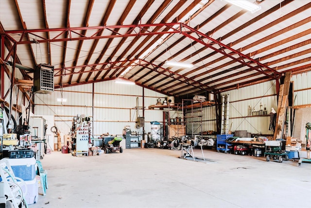 2098 Fisher Ct, Howell, MI 48855 - garage featuring a workshop area and a heating unit