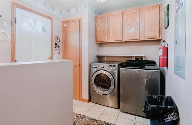 2098 Fisher Ct, Howell, MI 48855 - washroom featuring independent washer and dryer, light tile patterned flooring, cabinet space, and electric panel